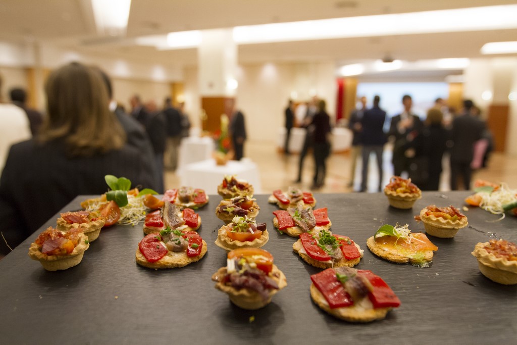 Canapés of different types served on a blackboard.