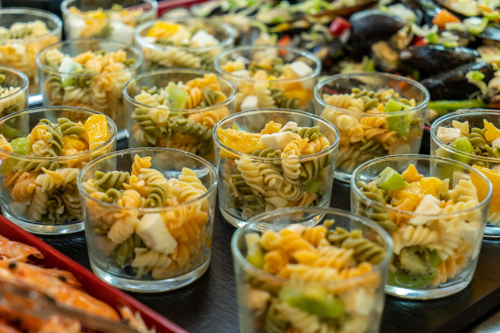 Pasta salads with kiwi and peach fetta cheese.