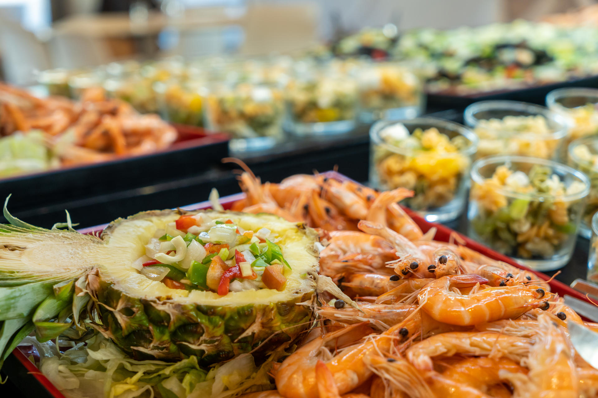 Pasta salads with kiwi and peach fetta cheese, pepper and onion salad on pineapple and fresh shrimp.