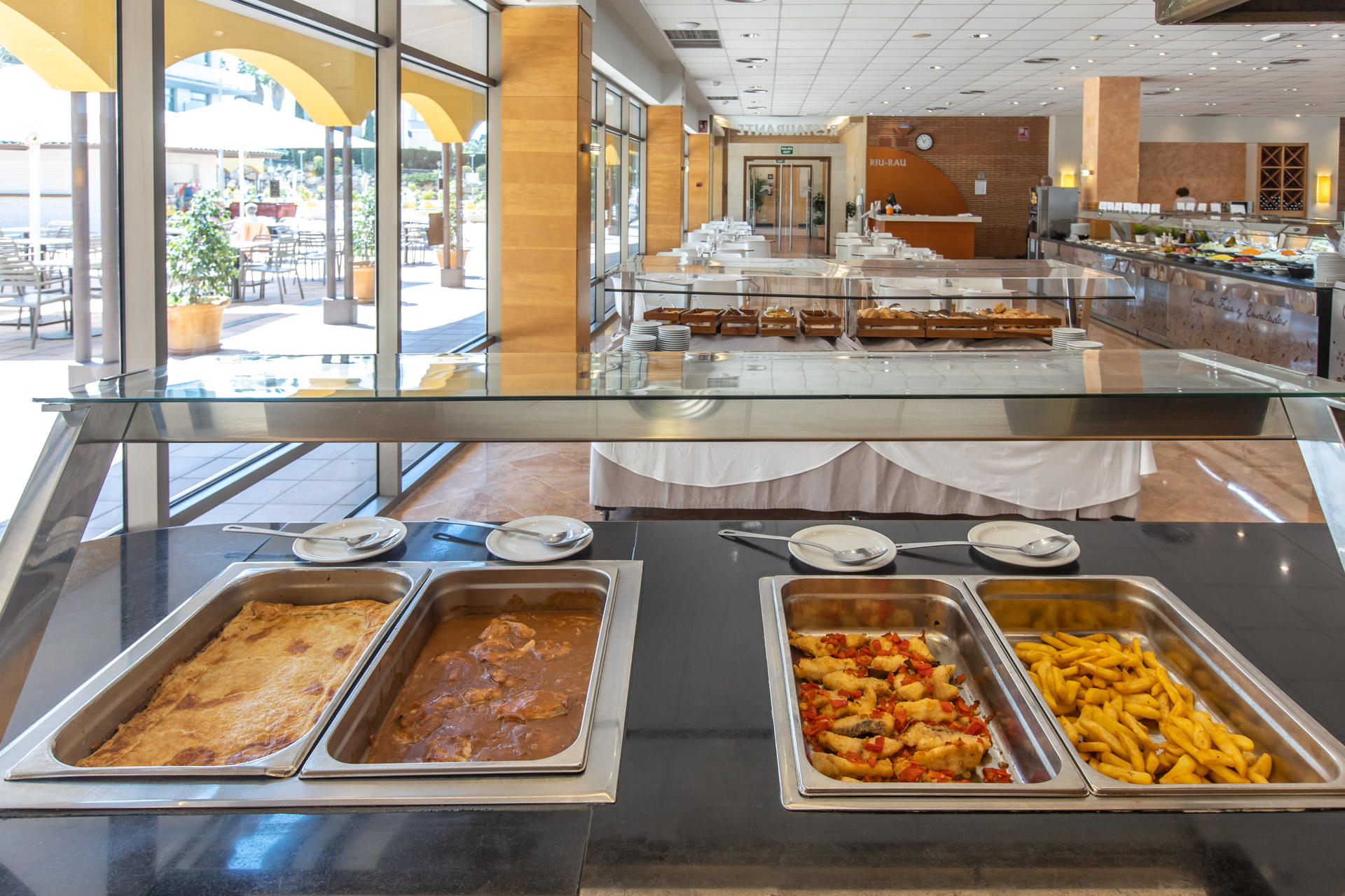 French fries, fried fish with peppers, meat in sauce, empanada