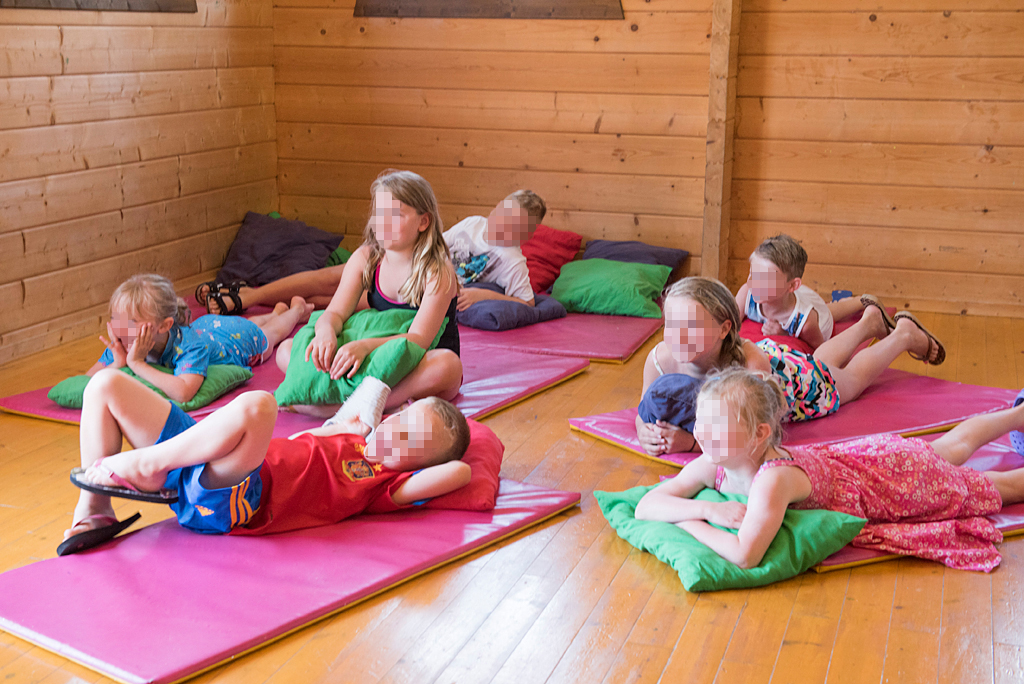 Children resting after playing in hotel activities.