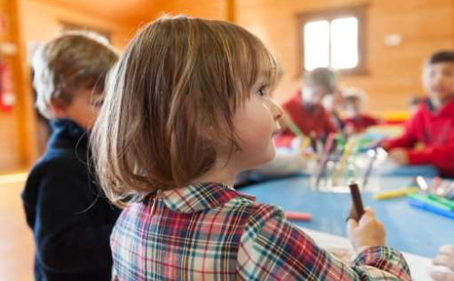 Children sitting at their tables to draw and do the rest of the hotel's activities.