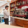 Cafeteria shelf with coffee machine, coffee grinders and bottle of alcohol of all kinds: brandy, whiskey, beilis, gin, martini, rum, liqueurs...