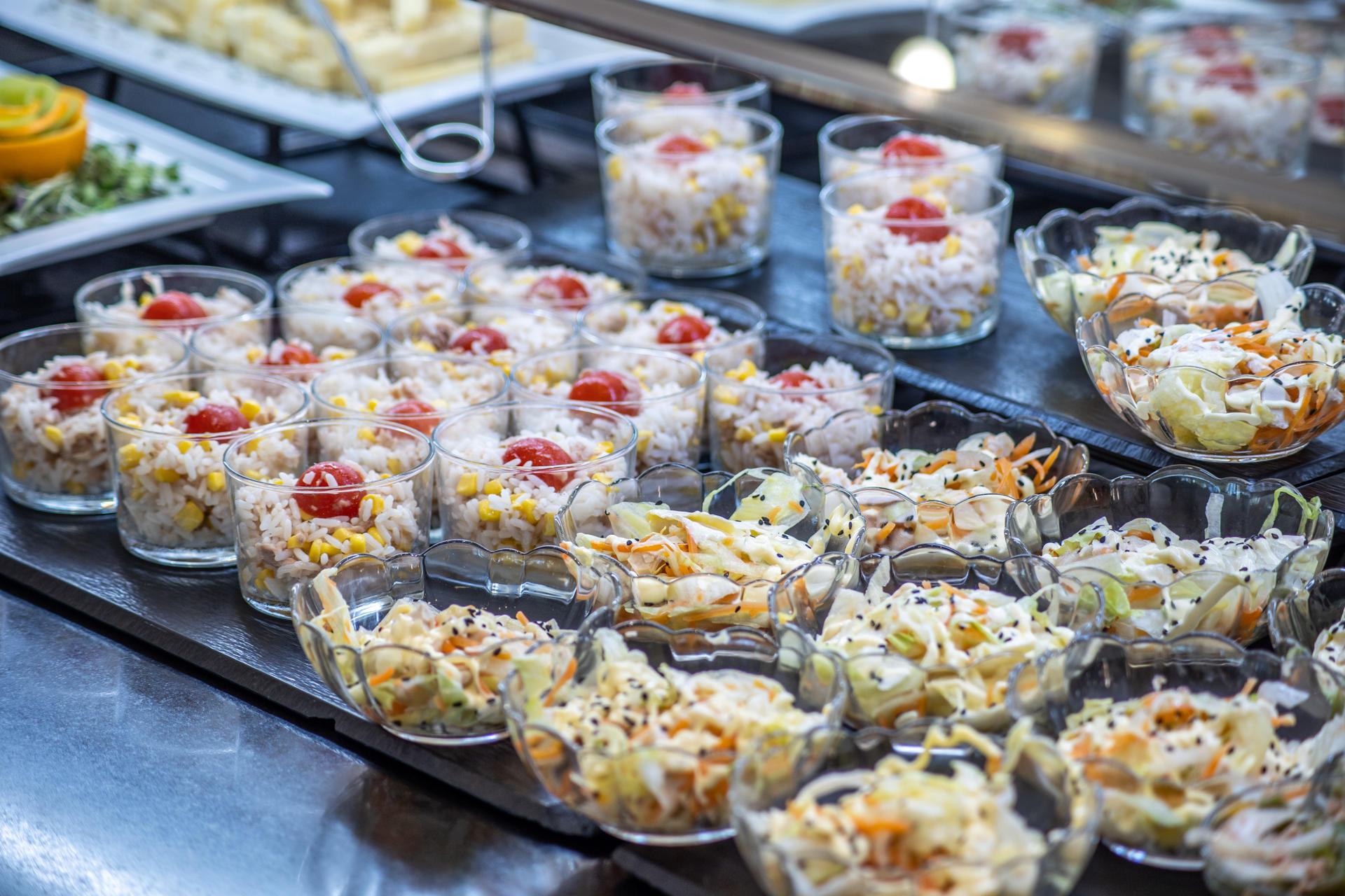 Carrot lettuce salad and Caesar sauce, rice, corn and cherry tomato salad.